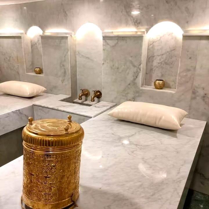 White marble hammam with brass taps
